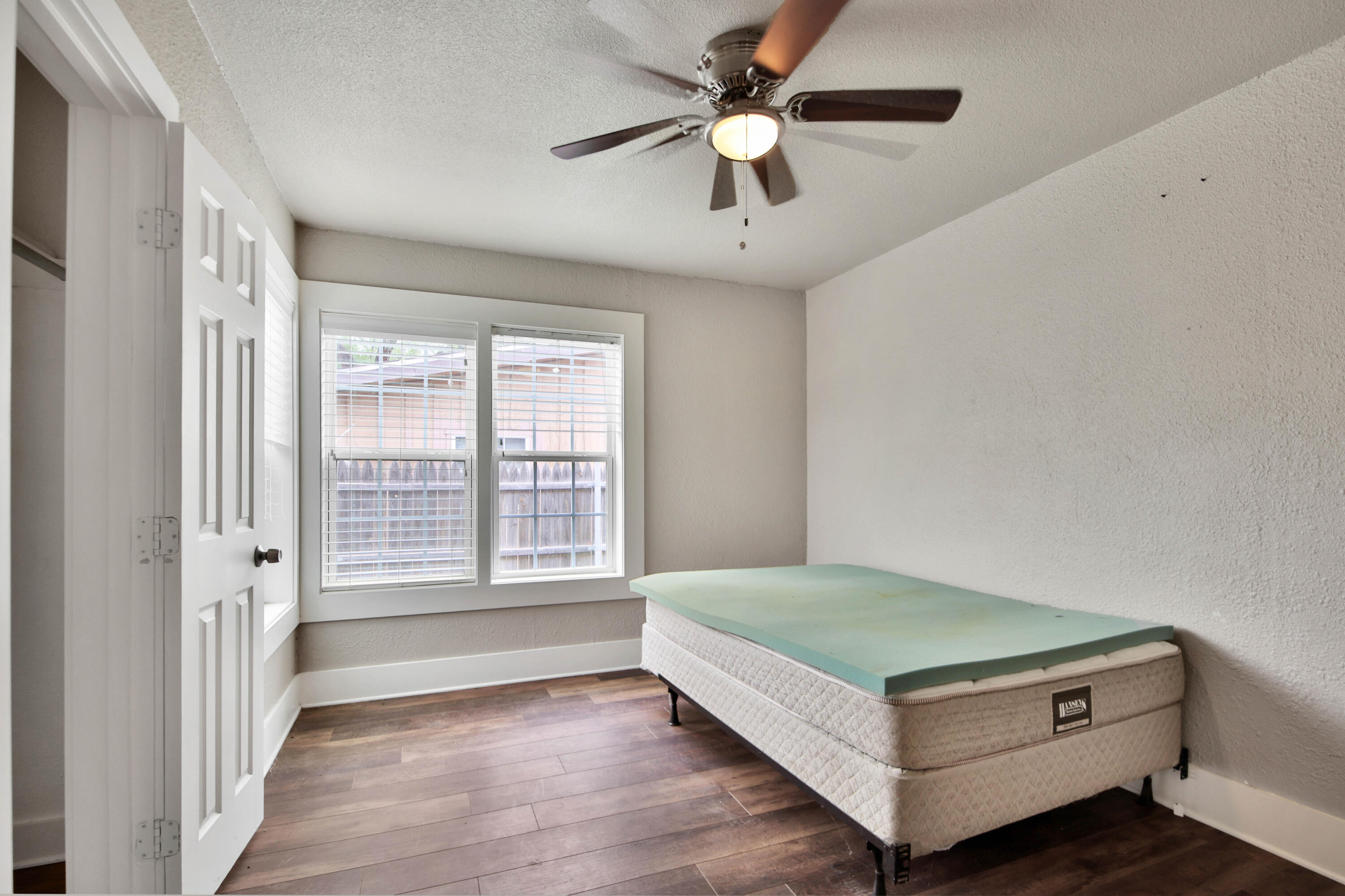 2408 24th Street Lubbock, TX 79411 - Photo 27 of 32 a living room with a bed furniture and a large window