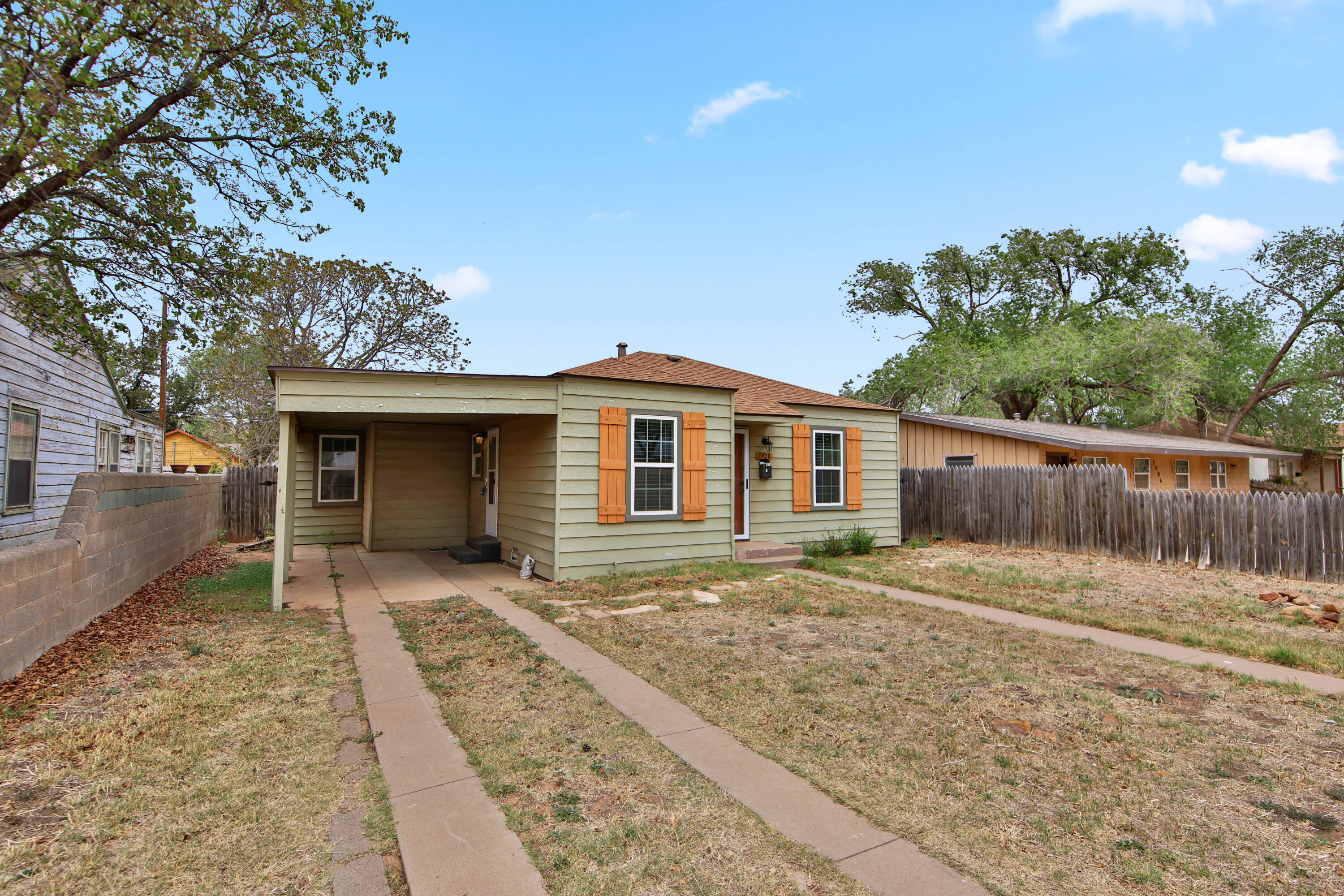 2408 24th Street Lubbock, TX 79411 - Photo 3 of 32 a front view of a house with a yard