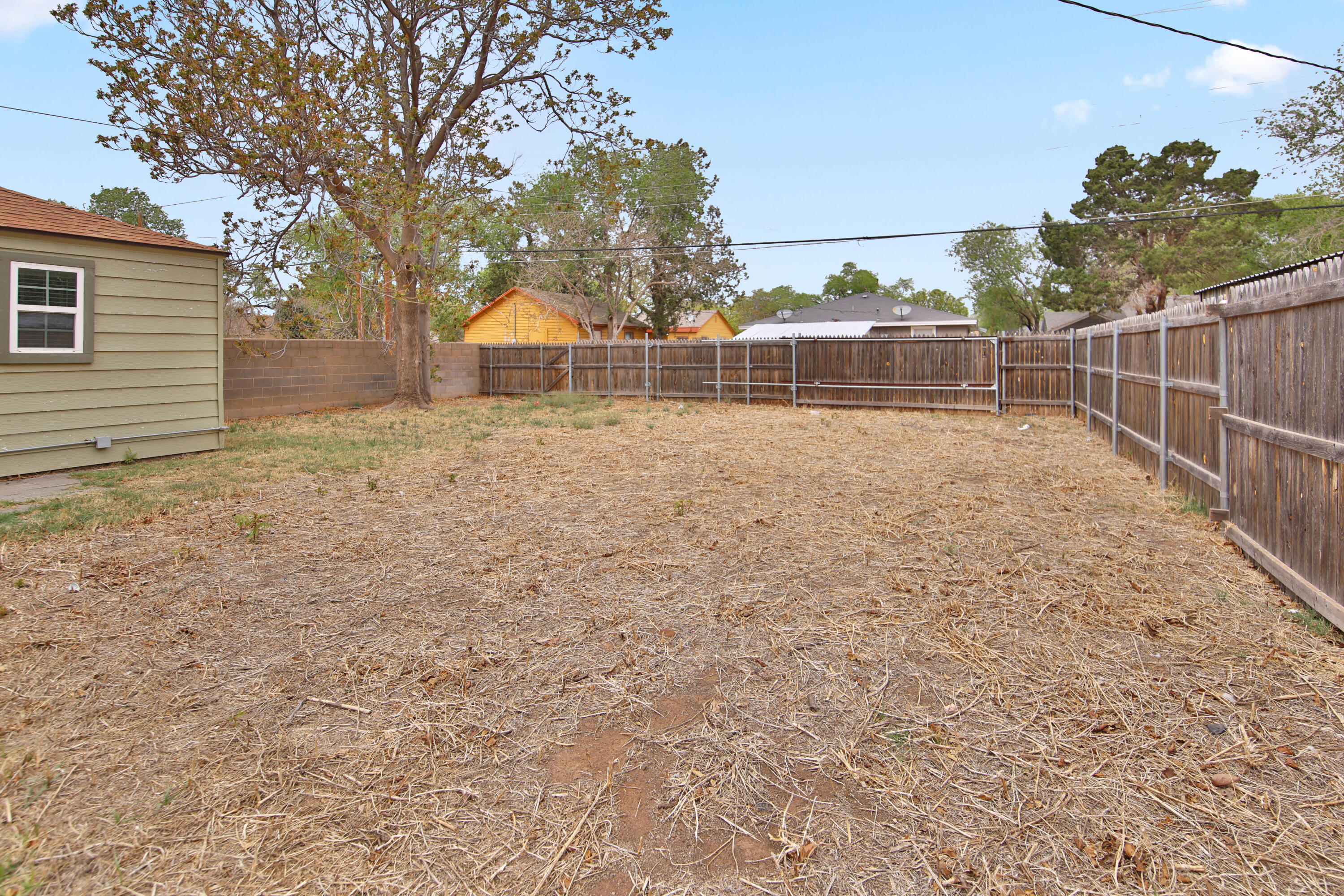 2408 24th Street Lubbock, TX 79411 - Photo 31 of 32 a backyard of a house with lots of green space