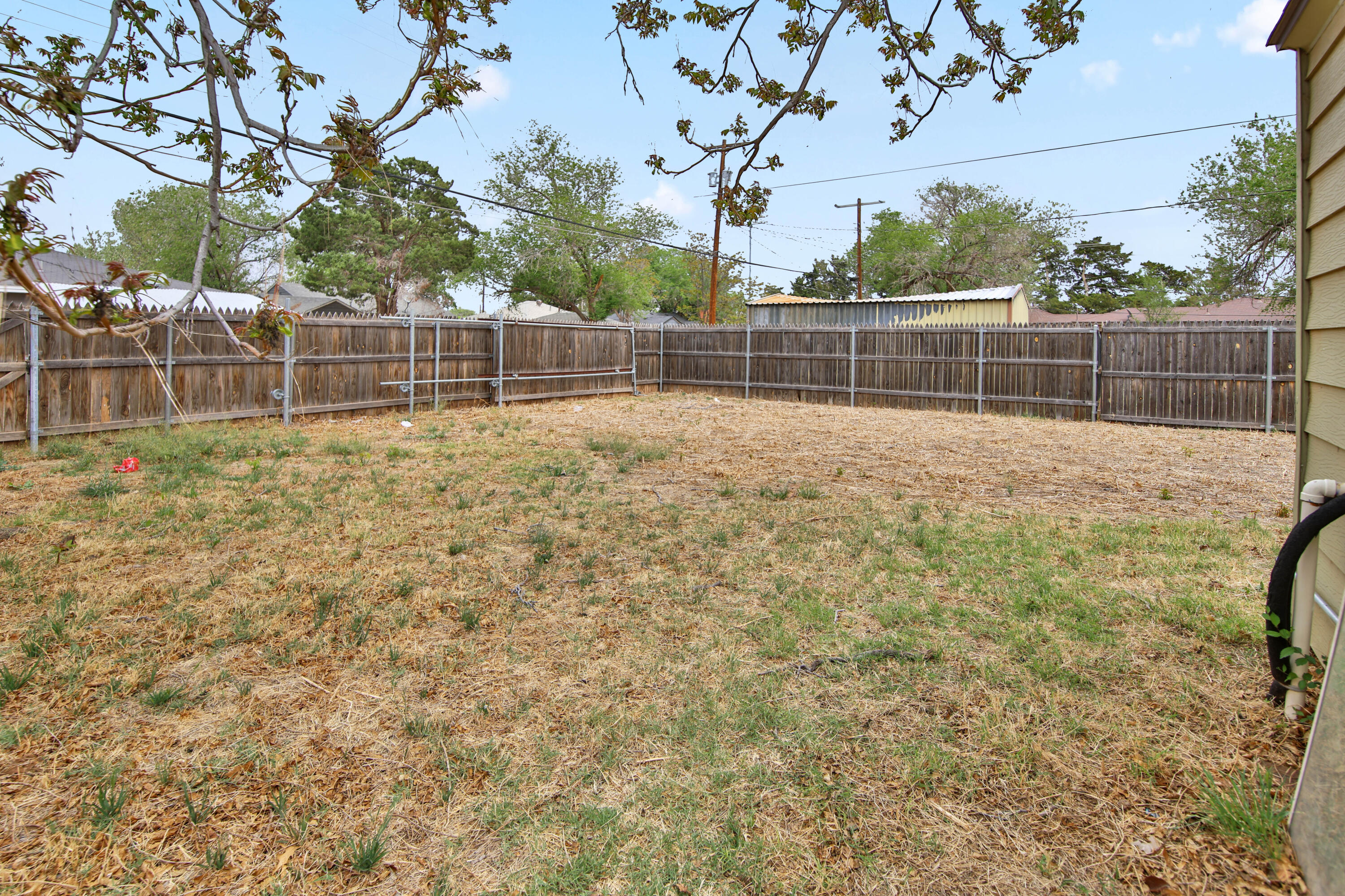 2408 24th Street Lubbock, TX 79411 - Photo 32 of 32 a view of a yard with a wooden fence