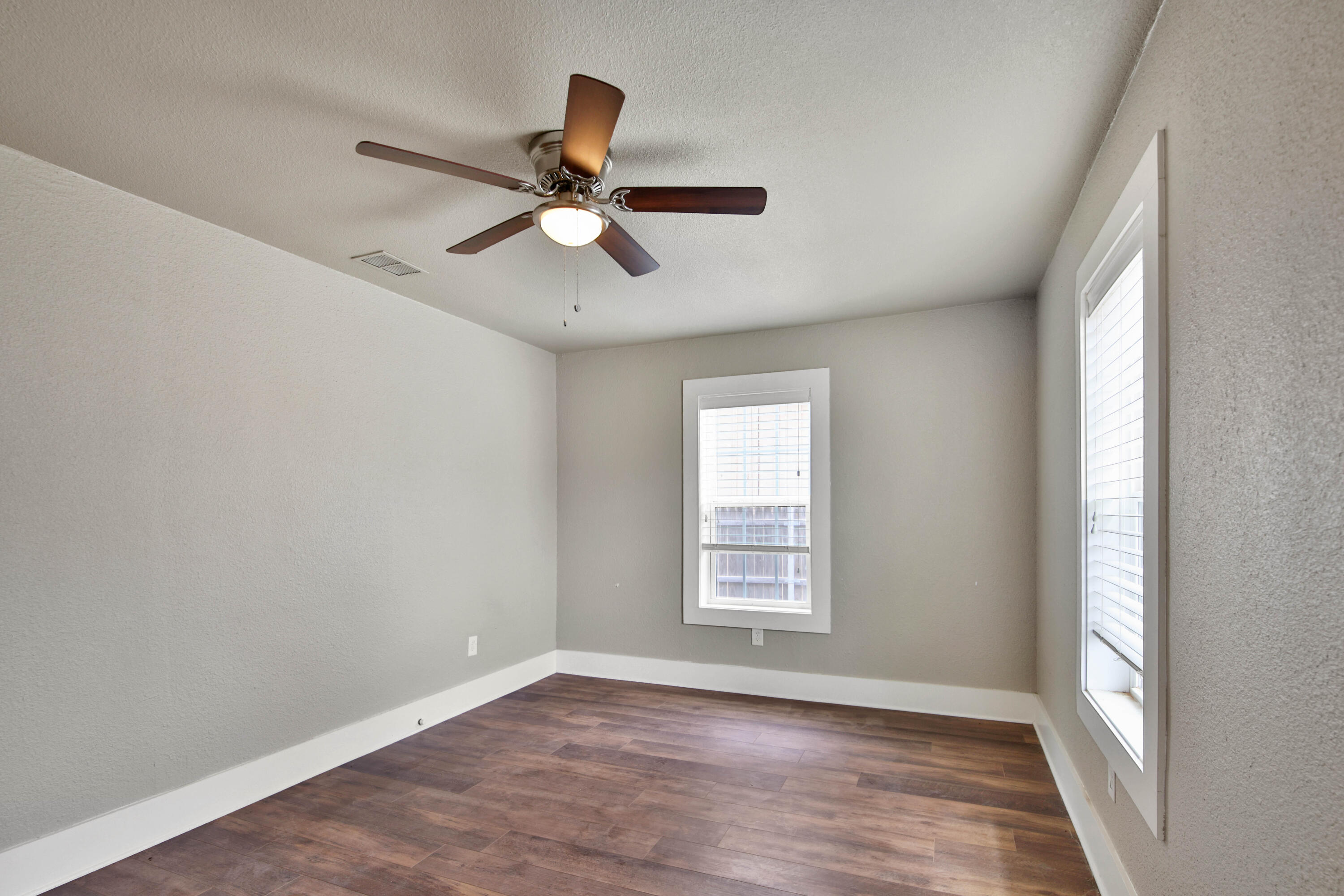2408 24th Street Lubbock, TX 79411 - Photo 7 of 32 wooden floor in an empty room with a window