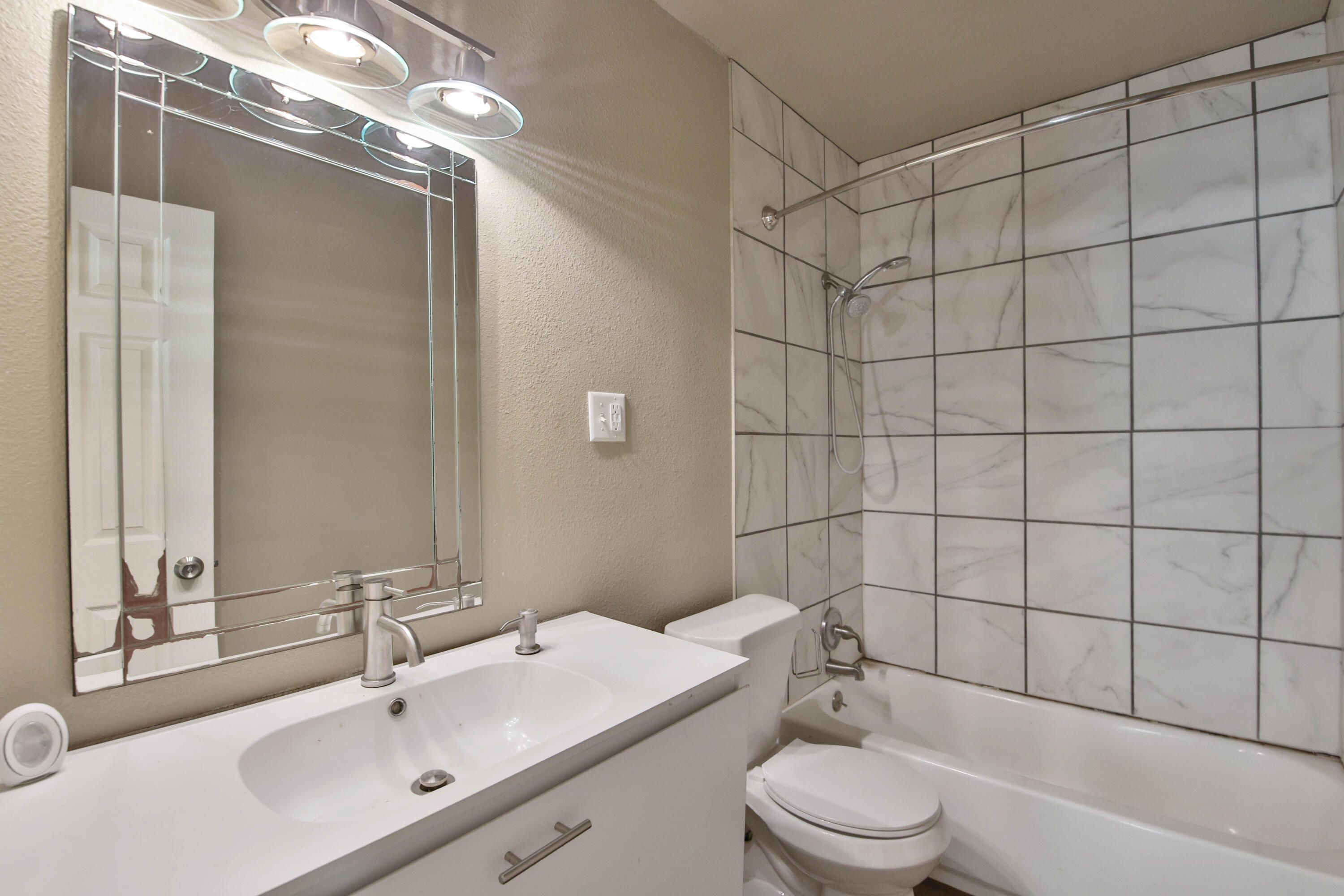 2408 24th Street Lubbock, TX 79411 - Photo 10 of 32 a bathroom with a sink toilet and shower