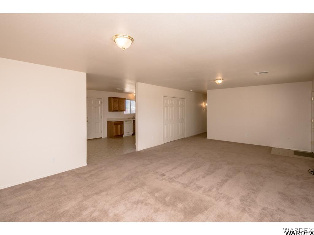 3620 Bosque Road Golden Valley, AZ 86413 - Photo 20 of 35 a view of a big room with wooden floor and windows