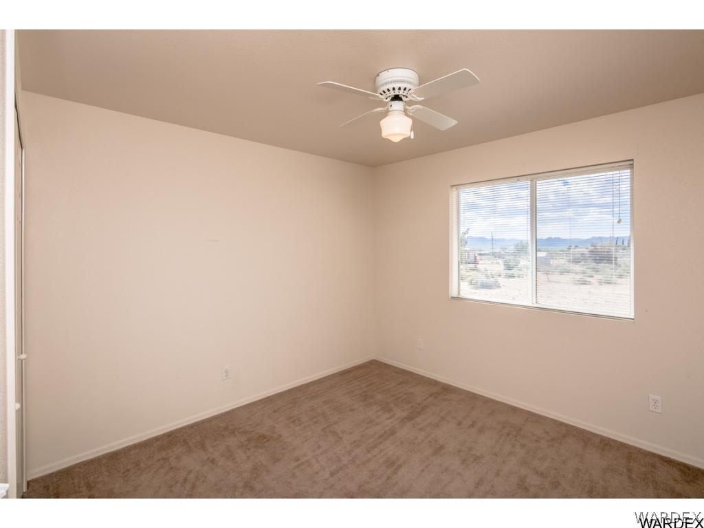 3620 Bosque Road Golden Valley, AZ 86413 - Photo 7 of 35 an empty room with windows and fan