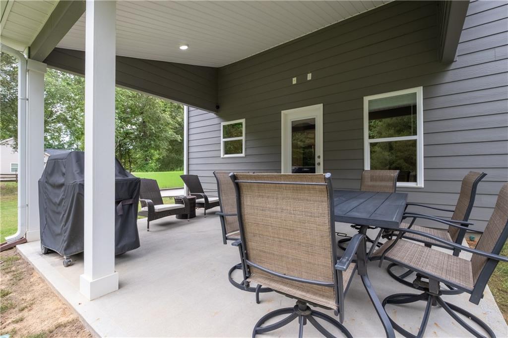 719 Fairview Road Brooks, GA 30205 - Photo 30 of 35 a view of a patio with a table and chairs