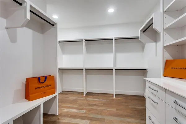 a view of walk in closet with empty racks