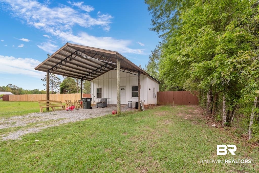 13742 Roberts Road Loxley, AL 36551 - Photo 2 of 18 Front view of house featuring fence, board and batten siding, and a yard