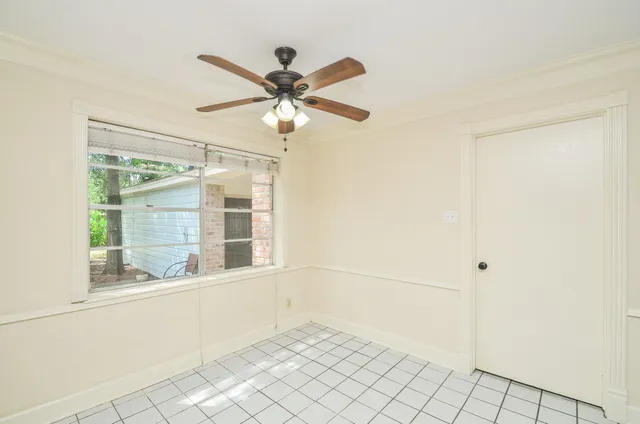 a view of a livingroom with wooden floor and a fireplace
