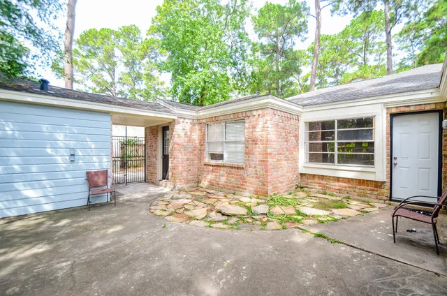 a view of backyard with swimming pool and green space