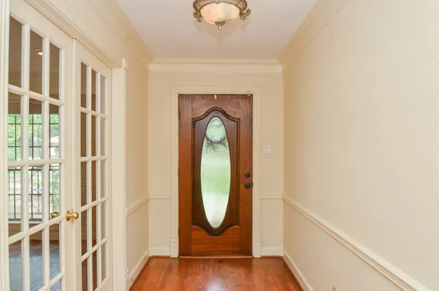 a view of a livingroom with wooden floor and a large window