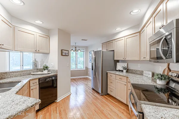 a view of a refrigerator in kitchen and wooden floor