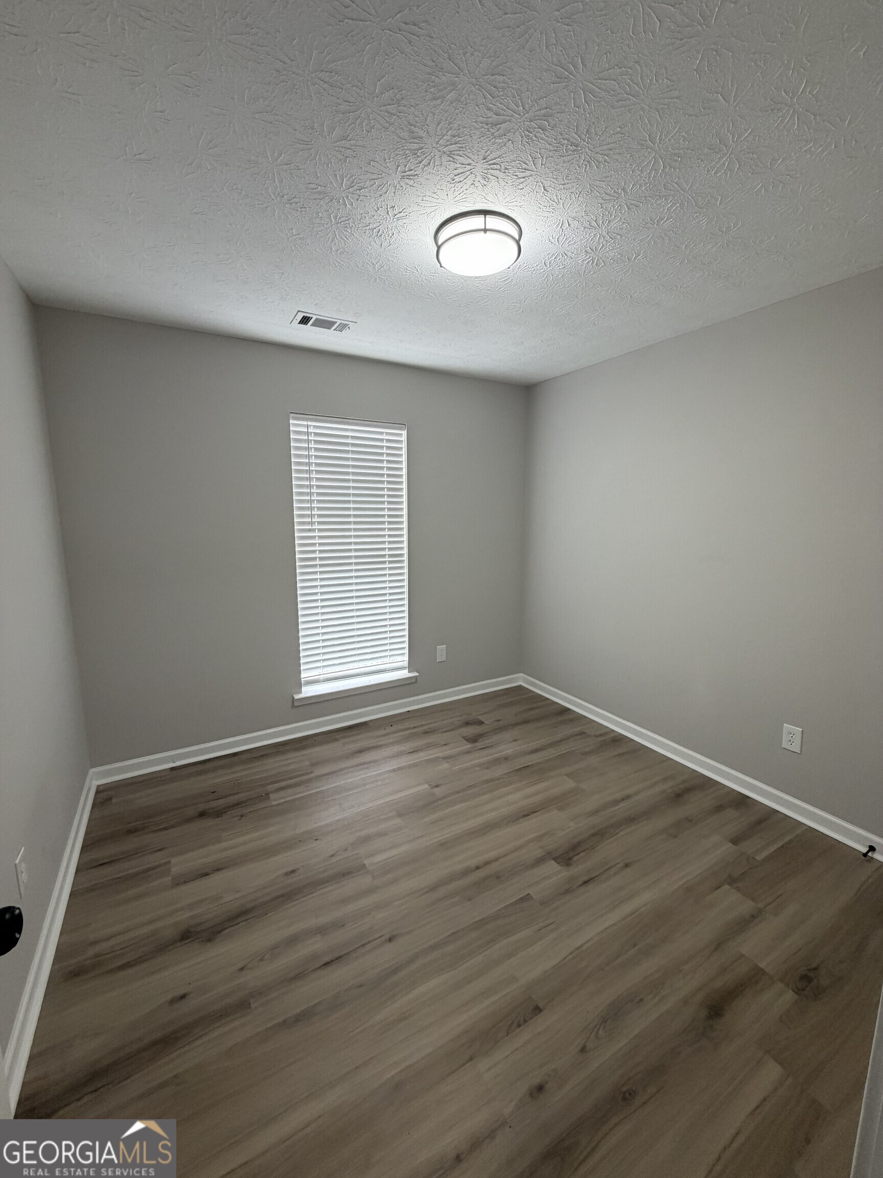 5773 Marlette Court Columbus, GA 31907 - Photo 12 of 21 a view of an empty room with wooden floor and a window