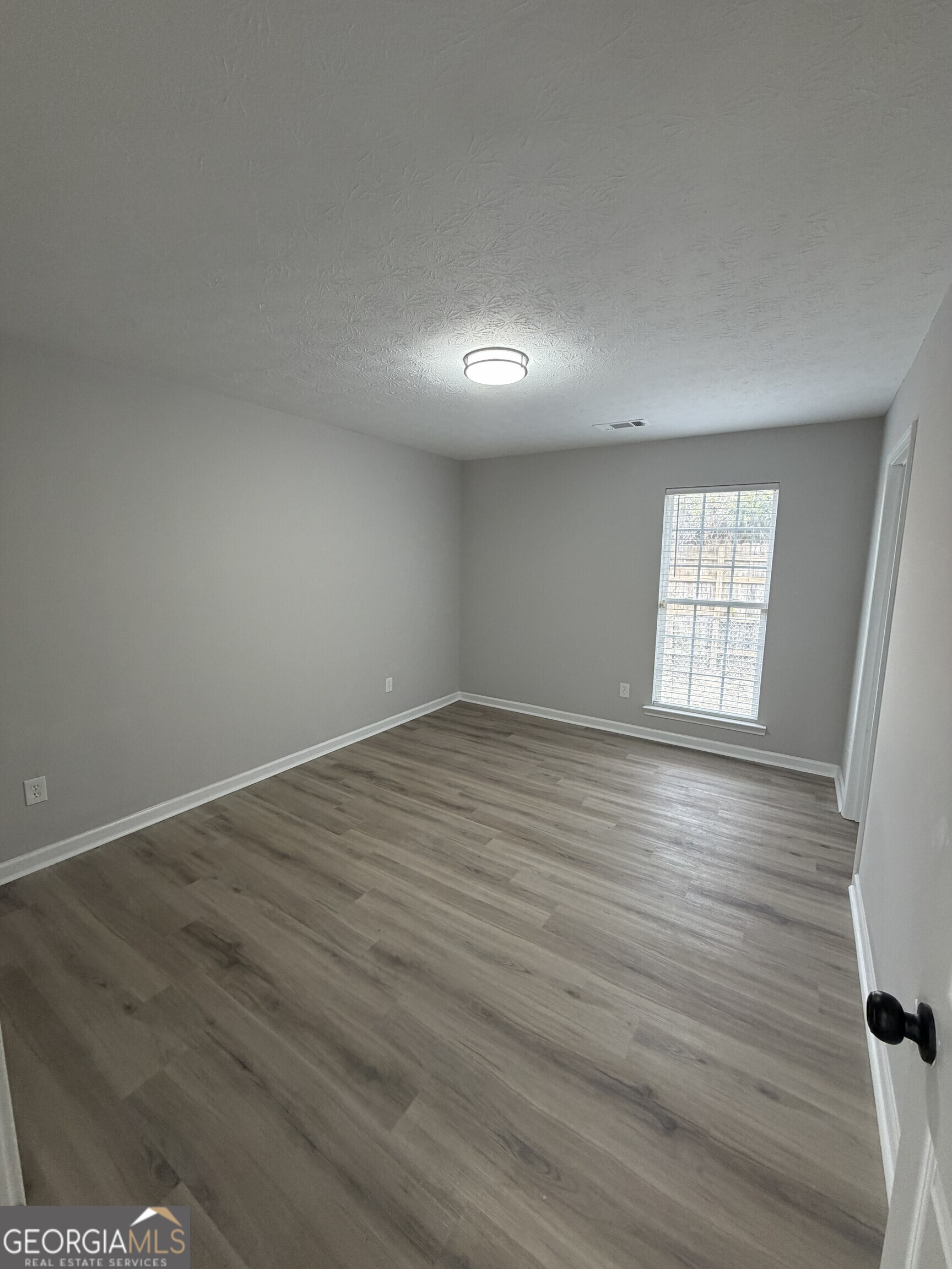 5773 Marlette Court Columbus, GA 31907 - Photo 14 of 21 an empty room with wooden floor and windows