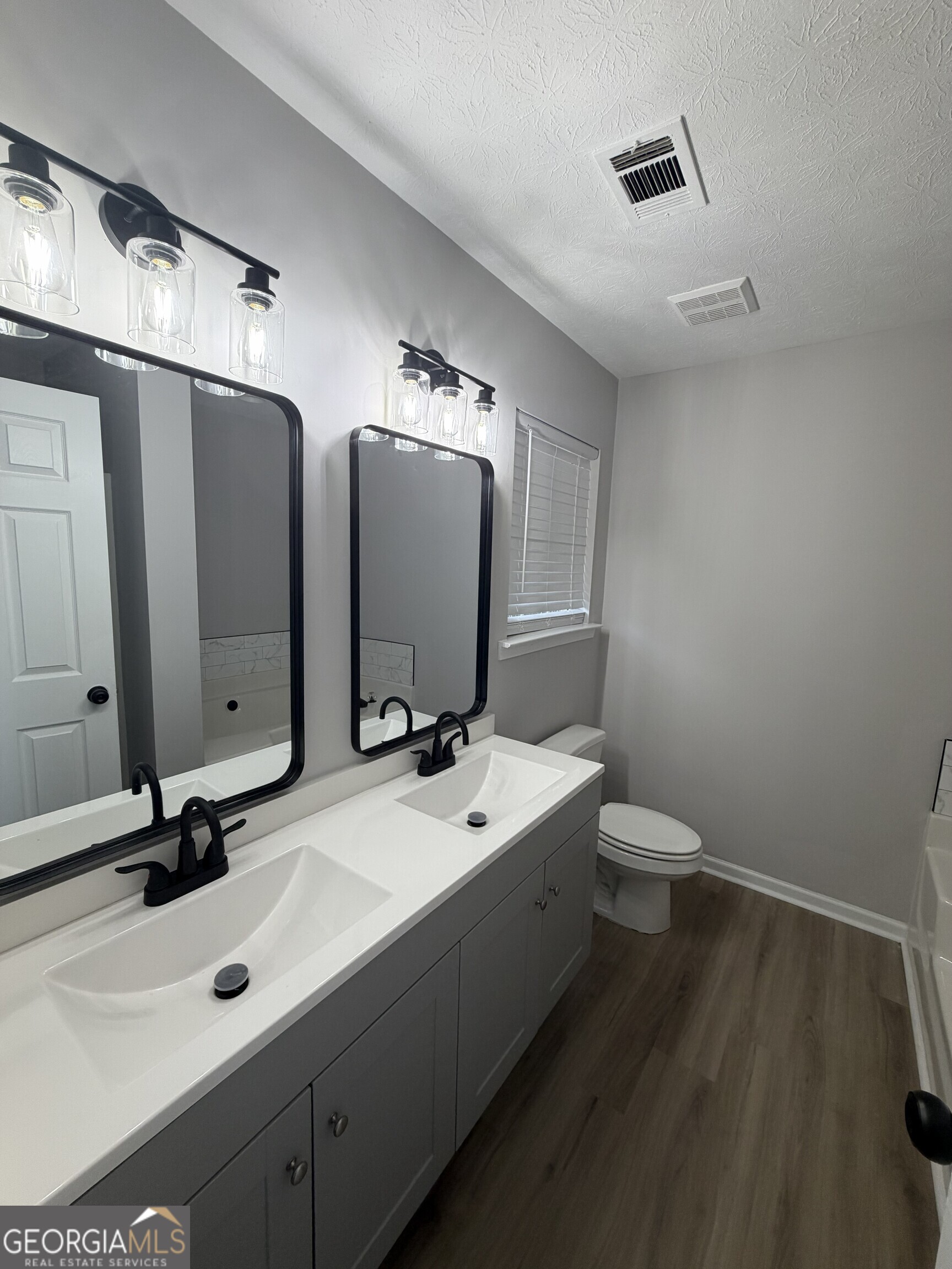 5773 Marlette Court Columbus, GA 31907 - Photo 16 of 21 a bathroom with a double vanity sink and mirror