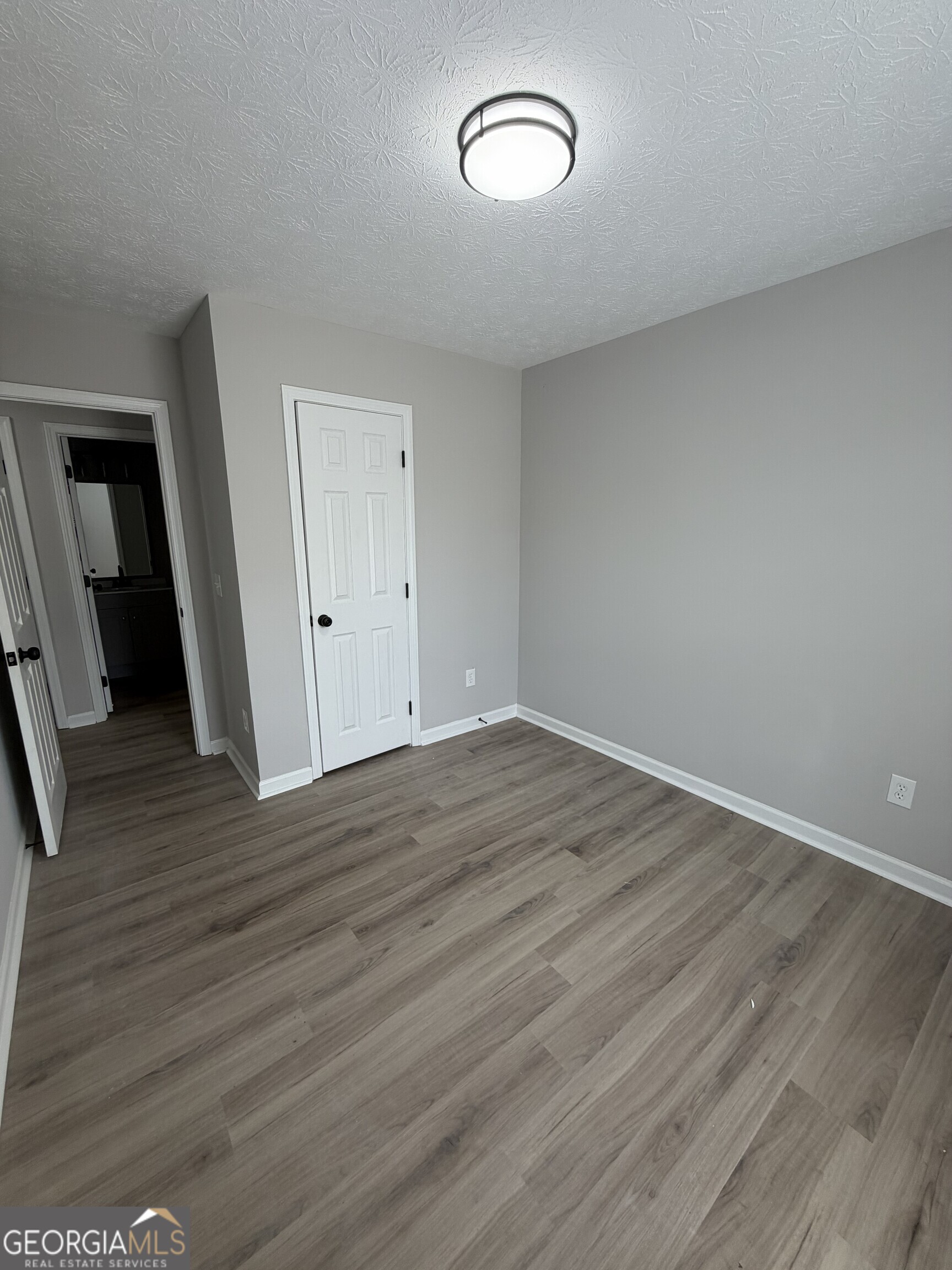 5773 Marlette Court Columbus, GA 31907 - Photo 10 of 21 an empty room with wooden floor and mirror