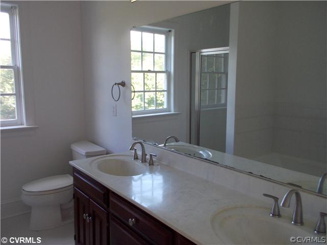 1920 Corner Rock Road Midlothian, VA 23113 - Photo 18 of 23 a bathroom with a granite countertop sink a toilet and a window