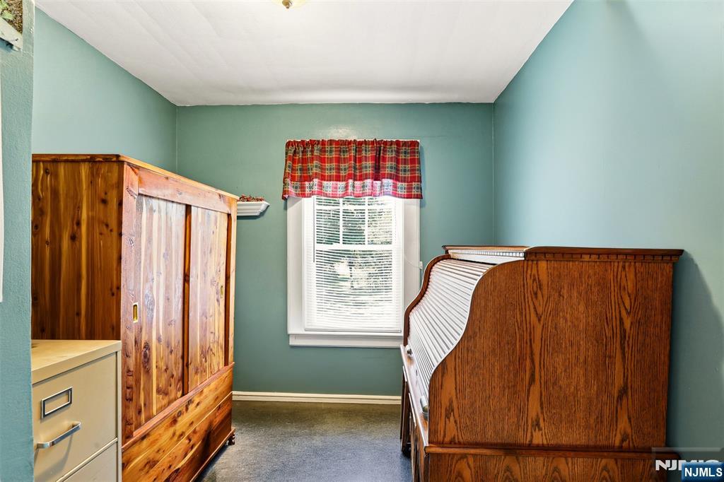 332 Riverside Avenue Lyndhurst, NJ 07071 - Photo 24 of 31 a bed sitting in a room next to a window
