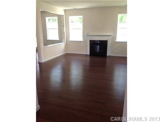 78110 Rillstone Drive Lancaster, SC 29720 - Photo 4 of 10 a view of a livingroom with wooden floor and a fireplace