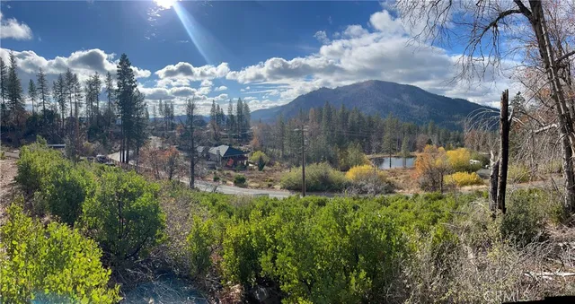 a view of a lake in middle of green field