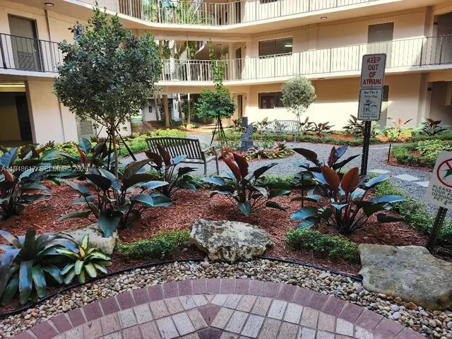 a view of a swimming pool with lawn chairs and couches