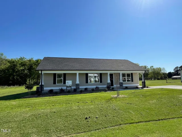a front view of house with yard and green space