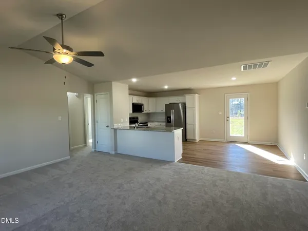 a view of a kitchen with a sink and a ceiling fan