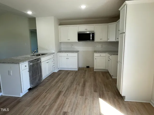 a kitchen with a sink a stove and cabinets