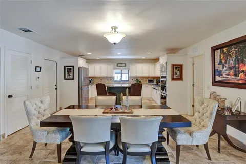 a kitchen with stainless steel appliances granite countertop a stove and white cabinets