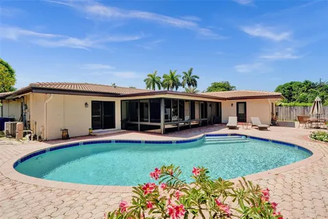 an aerial view of a house with a swimming pool