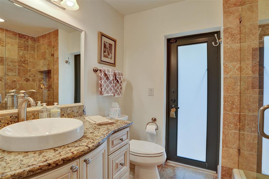 2000 Northeast 31st Avenue Fort Lauderdale, FL 33305 - Photo 31 of 47 a bathroom with a granite countertop sink a toilet and a mirror