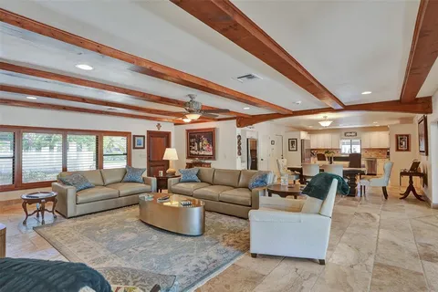 a kitchen with stainless steel appliances kitchen island granite countertop a stove top oven a sink dishwasher and a microwave