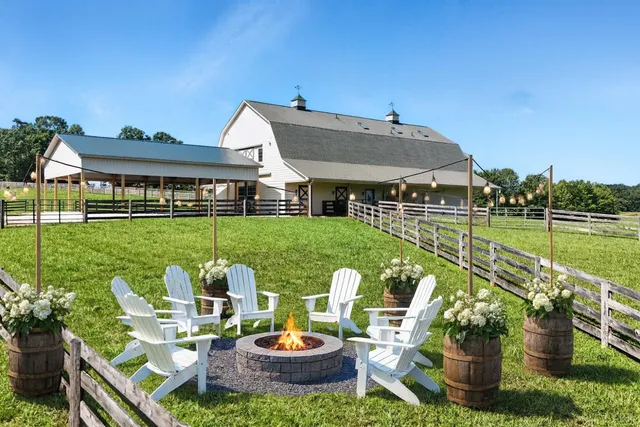 a view of a house with backyard sitting area and swimming pool