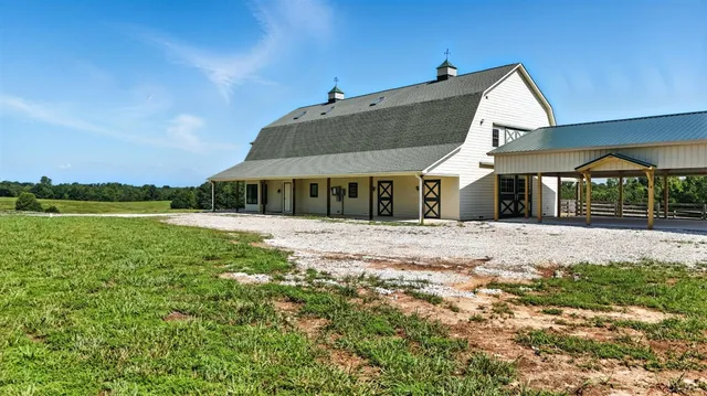 a kitchen with stainless steel appliances granite countertop a refrigerator a stove a sink dishwasher with a dining table and chairs with wooden floor