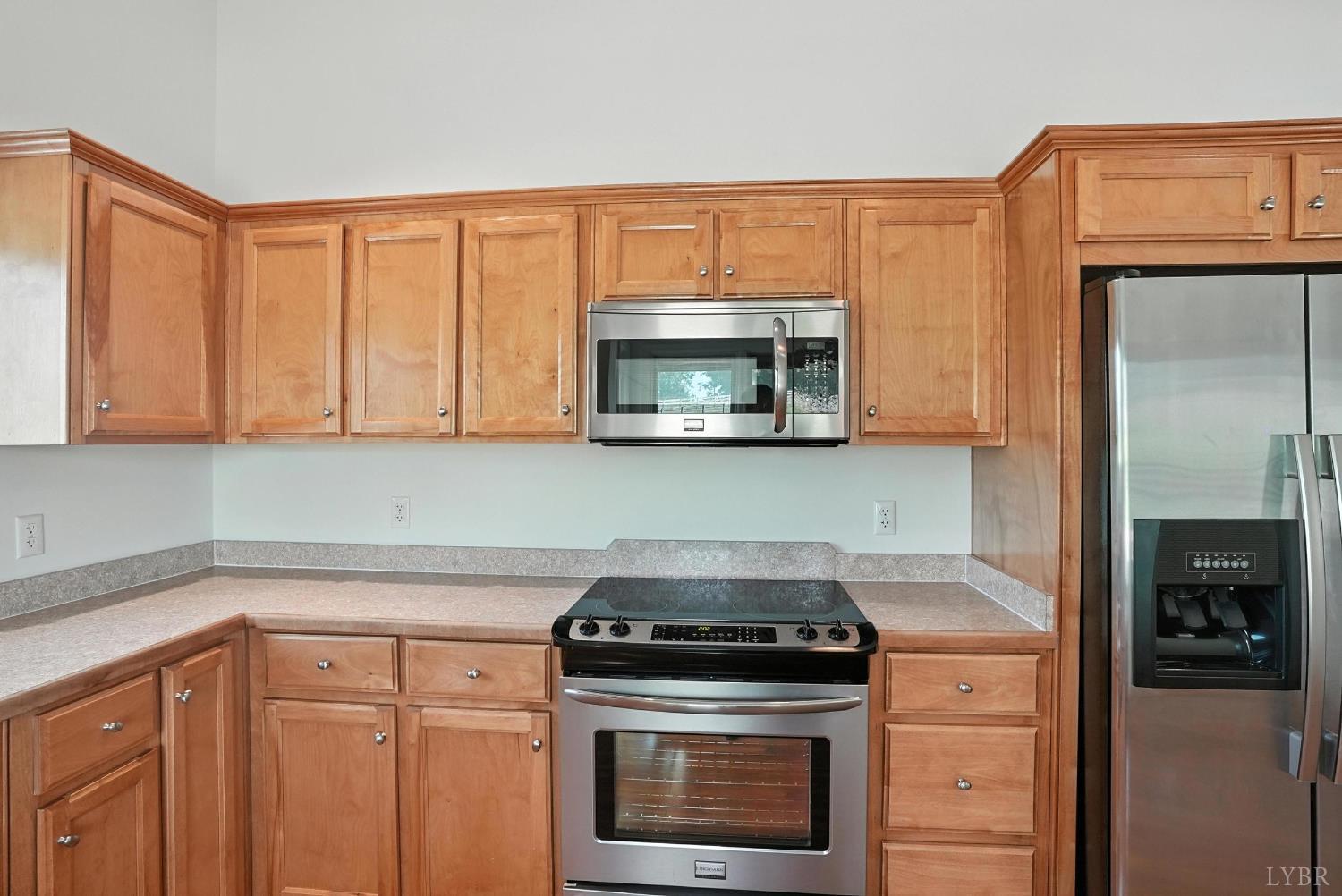 1433 Piney Mountain Road Appomattox, VA 24522 - Photo 20 of 68 a kitchen with granite countertop a stove top oven microwave and cabinets