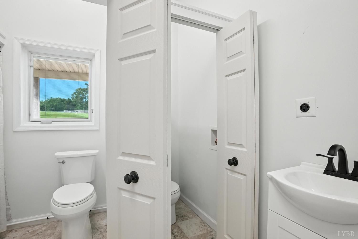 1433 Piney Mountain Road Appomattox, VA 24522 - Photo 31 of 68 a bathroom with a sink toilet and shower