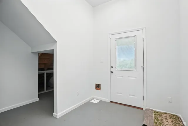 a view of a balcony with wooden floor next to a iron stairs
