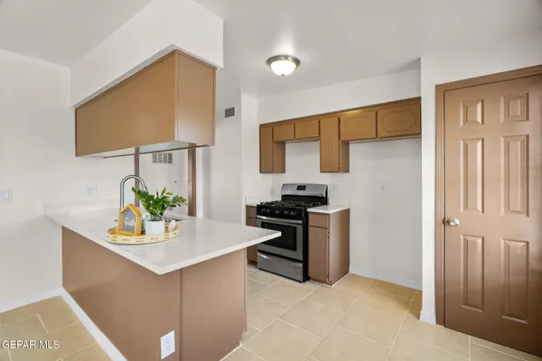 a kitchen with stainless steel appliances a stove and a refrigerator