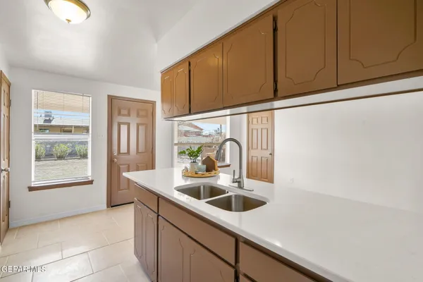 a kitchen with stainless steel appliances granite countertop a sink and a microwave