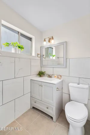 a bathroom with a sink mirror vanity and toilet