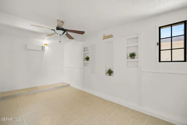 a view of a livingroom with a ceiling fan and window