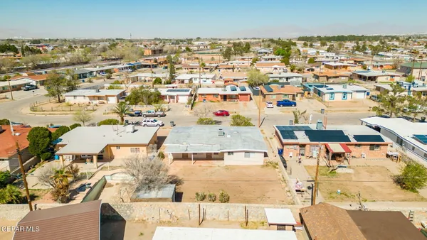 an aerial view of a houses with a swimming pool