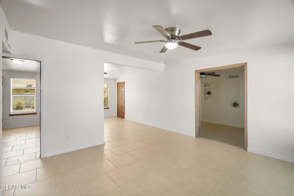 a view of an empty room and a bathroom