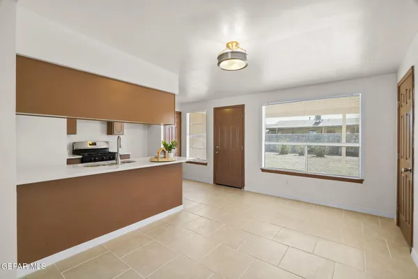a large kitchen with a large window cabinets and stainless steel appliances