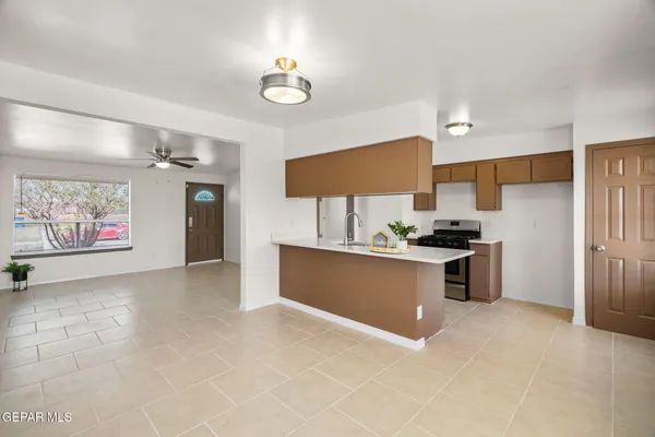 a kitchen with stainless steel appliances a stove refrigerator sink and microwave