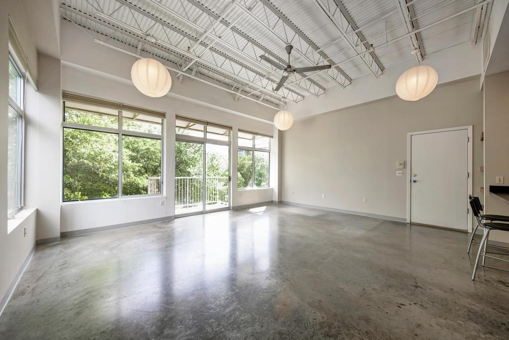 2401 East 6th Street, Unit 3046 Austin, TX 78702 - Photo 7 of 35 Open concept loft with high ceilings and windows facing trees