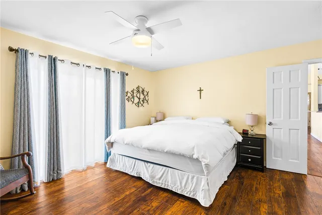 a spacious bedroom with a bed and a window