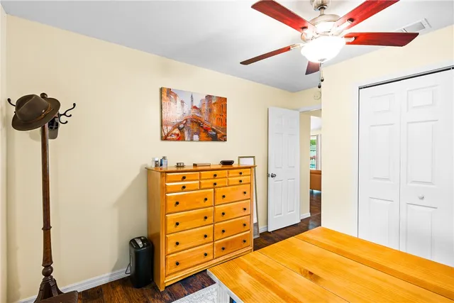 a bedroom with a bed and a cabinet