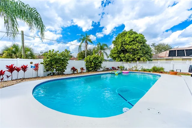 a view of a swimming pool with an outdoor seating and a garden