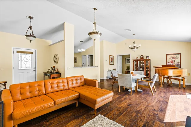 a living room with furniture a table and a chandelier