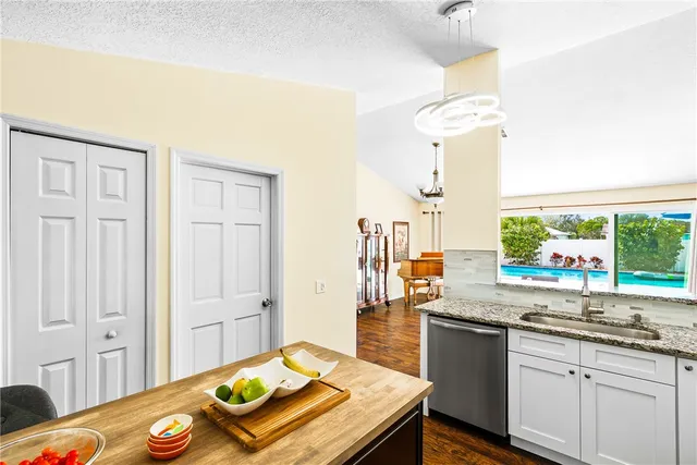 a kitchen with a sink stove and view living room
